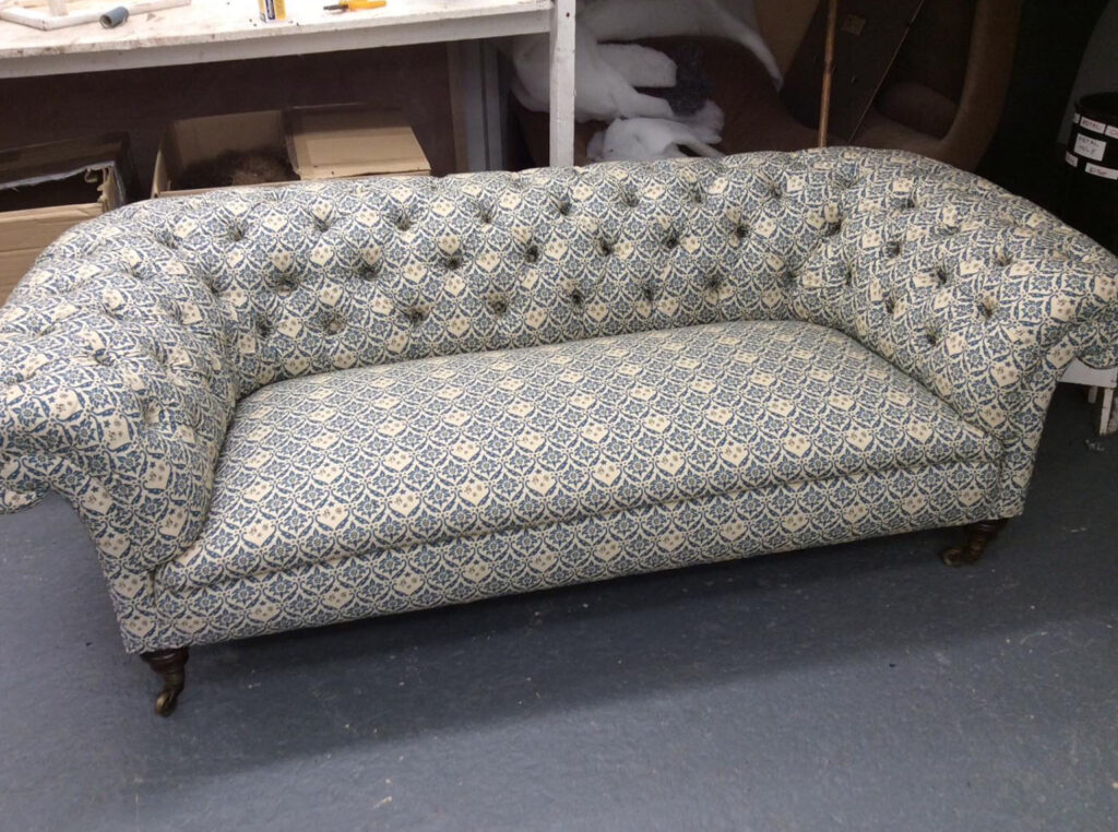 Chesterfield sofa reupholstered in blue and cream patterned fabric